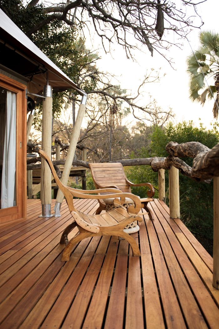 The Art of Drawing Readers In: Your attractive post title goes here Two wooden chairs on a rustic deck surrounded by lush nature.